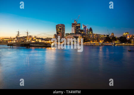 UK, London, Skyline at night with Hms Belfast in the foreground