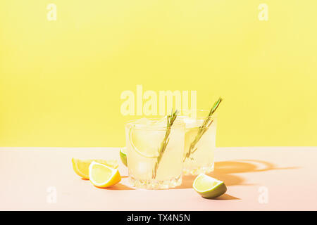 Italian traditional drink limoncello in glass goblets on a pastel yellow pink background. Alcoholic cocktail. Copy space. Selective focus Stock Photo