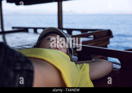 Indonesia, Komodo National Park, girl sleeping on a boat