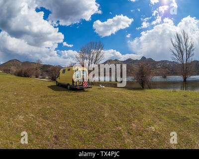 Spain, Asturias, Camposolillo, camper at Porma reservoir and Cantabrian Mountains in the back Stock Photo