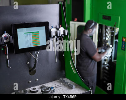 Man working on a machine Stock Photo