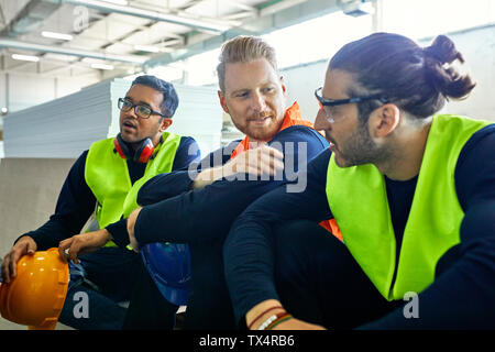 Workers in factory having a break together Stock Photo