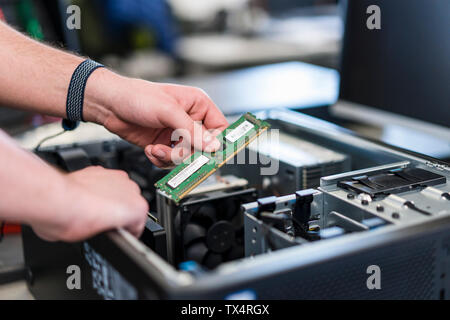 Close-up of teenager assembling personal computer Stock Photo