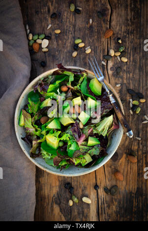 Various leaf salad with avocado, roasted seeds, almonds and soy beans Stock Photo
