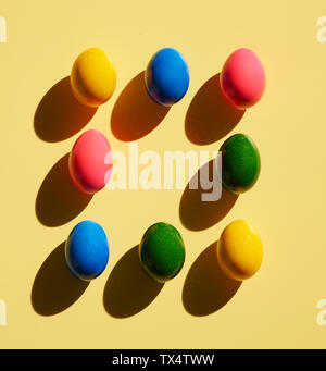 Dyed Easter eggs on yellow background Stock Photo