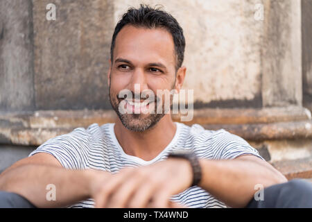 Portrait of smiling relaxed man in the city Stock Photo