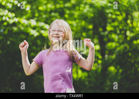 A jumping preschool girl with closed eyes Stock Photo