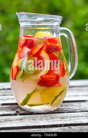 Detox water with strawberry, lime, lemon and mint in a glass jar Stock Photo