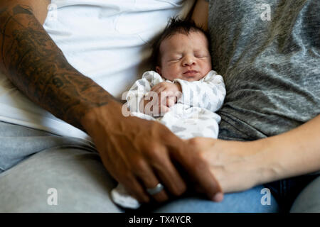 Newborn baby between his parents
