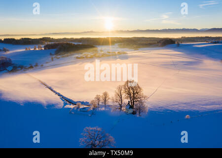 Germany, Bavaria, Degerndorf, winter landscape with Maria Dank chapel on Fuerst Tegernberg at sunrise, aerial view Stock Photo