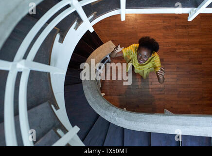 Top view of smiling woman standing on the ground floor Stock Photo
