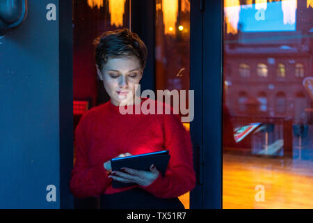 Germany, Berlin, portrait of businesswoman using digital tablet outdoors Stock Photo
