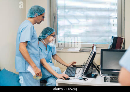 Doctors using computer at the hospital Stock Photo