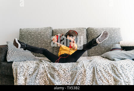 Excited boy playing video game on a games console Stock Photo