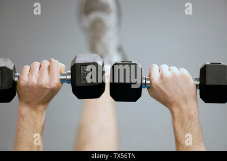 Man lifting weights in gym Stock Photo