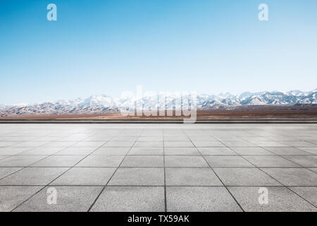 Empty floor with white snow mountains Stock Photo