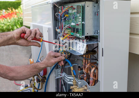 Heat Pump. plumber at work installing a circulation pump Stock Photo