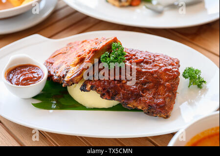 Grilled ribs pork with barbeque sauce on white plate Stock Photo