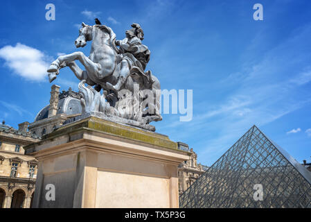 Main courtyard of the palace of the Louvre palace with an equestrian statue of king Louis XIV Stock Photo