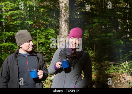 A couple drinking coffee outside at a campground in New York State. Stock Photo