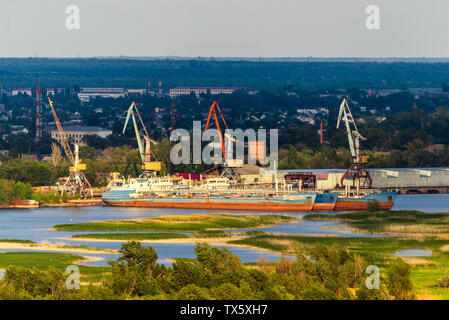 Cargo terminal and port cranes on the river. Stock Photo