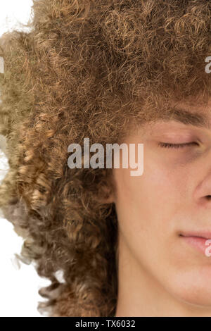 Cropped portrait of a young curly European man with long curly