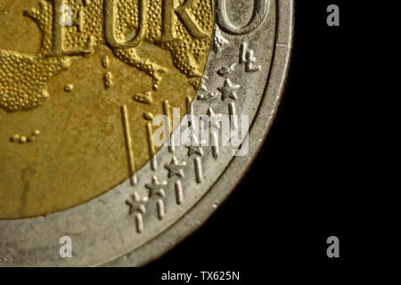 two euro coin close up isolated on black background. Detail of metallic money close up. EU money. Stock Photo