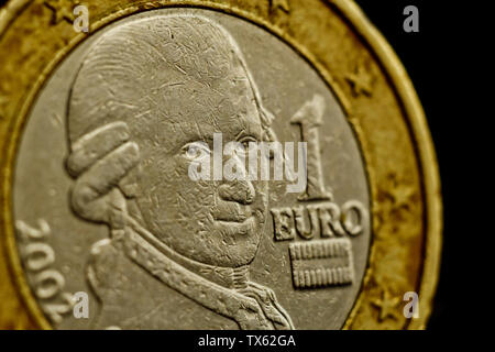 one euro coin close up isolated on black background. Detail of metallic money close up. EU money. Stock Photo