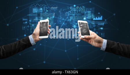Close up of two hands holding smartphones to sync business data Stock Photo