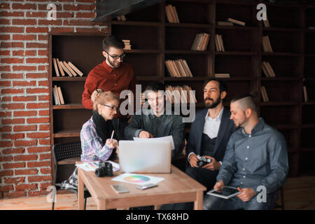 successful group of designers discussing a new advertising project.photo with copy space Stock Photo