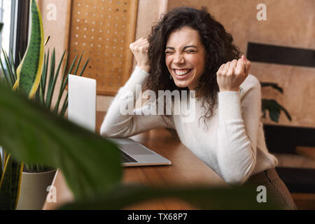 Portrait of emotional cute girl using laptop Stock Photo - Alamy