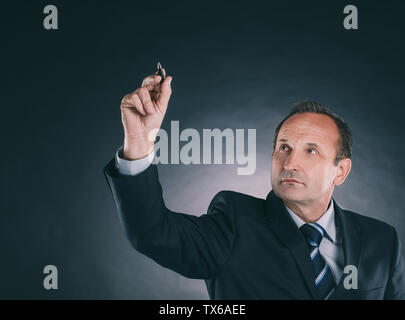 businessman writing on a virtual chalkboard. Stock Photo