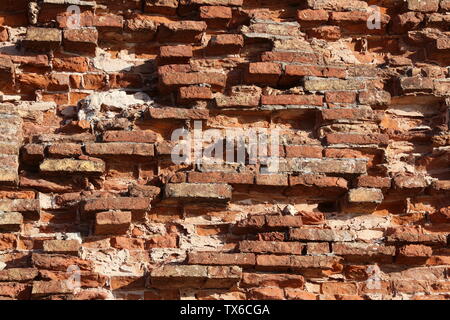 The old red brick fortress wall is crumbling Stock Photo