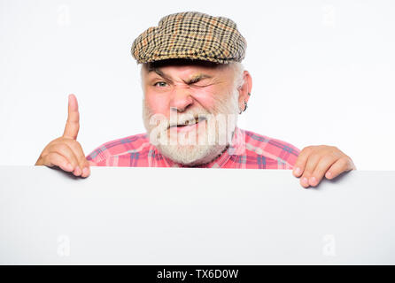 Elderly person. Senior bearded emotional man peek out of banner place announcement. Pensioner grandfather in vintage hat poster information copy space. Announcement concept. Event announcement. Stock Photo