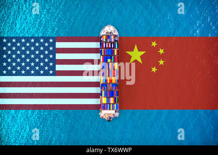 America flags and chinese flags with Cargo ship on ocean. USA and China trade war. Stock Photo