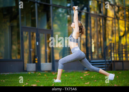 Healthy lifestyle. Fitness woman doing exercise in city environment Stock Photo