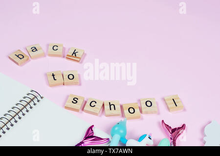 Collection of Stationary Items and Office Suppliers - pen, pencils, notebook with Inscription Back to School on pink background, copy space, top view, Stock Photo