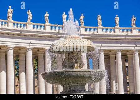 VATICAN - SEPTEMBER 25, 2018: Fountain by St. Peter's Basilica in Vatican. It is the world's largest church building. Stock Photo