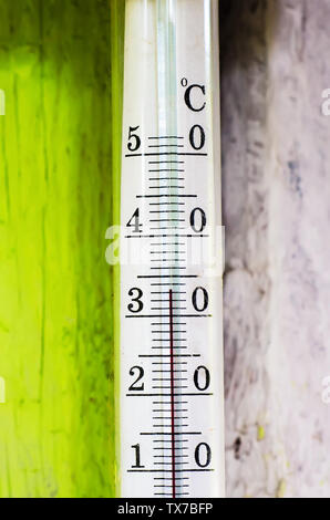 old thermometer outdoors in summer heat Stock Photo