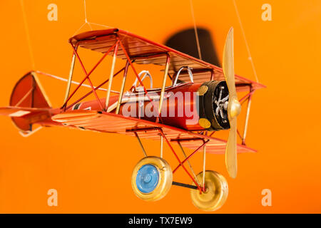 metal air plane toy display on yellow background Stock Photo