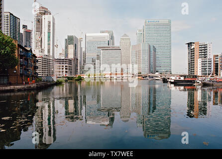 Canary Wharf from Blackwall Basin, London Docklands UK, with reflection in the water Stock Photo