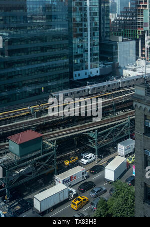 New York City Subway Train on elevated section of line above Traffic, near Queensboro Plaza, Long Island City, New York, USA Stock Photo
