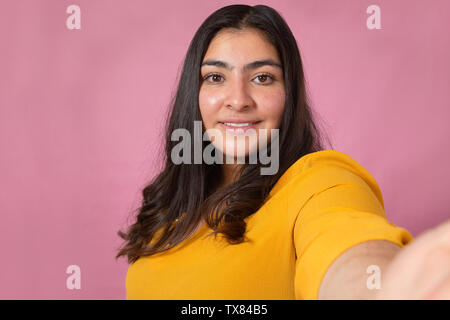 Cheerful Chubby Woman Taking Selfie On Smartphone While Resting With