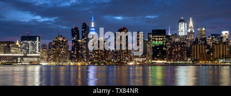 Manhatttan Skyline at night featuring the Empire State Building across the East River, New York, USA Stock Photo
