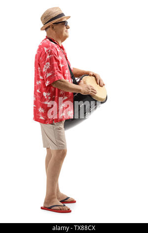 Full length profile shot of a mature man playing conga drums isolated on white background Stock Photo