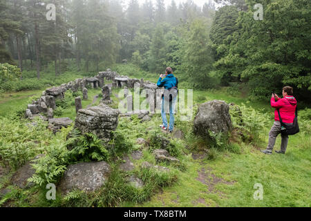 Masham, Yorkshire Dales, England, UK. 24th June, 2019. UK Weather: Tourists visit the Druids Temple, a folly on the Swinton Park estate near Masham in the Yorkshire Dales on a warm but damp and overcast day as heavy rain storms move north towards Scotland. Alan Beastall/Alamy Live News Stock Photo