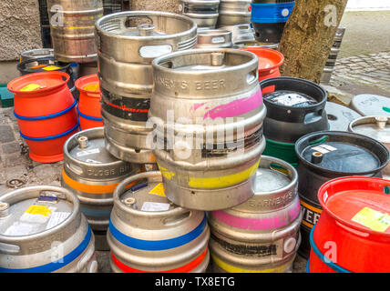 Empty metal beer barrels / kegs stacked up outside, around the back of a pub in Edinburgh, Scotland, UK. Stock Photo