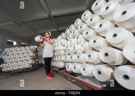 A woman in a textile factory. Stock Photo