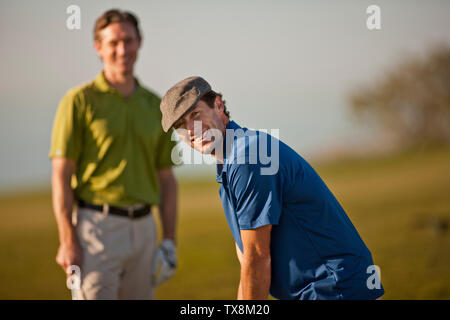 Portrait of a smiling mid adult man playing golf. Stock Photo