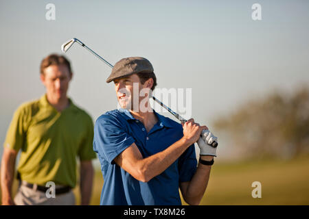 Smiling mid adult man playing golf. Stock Photo